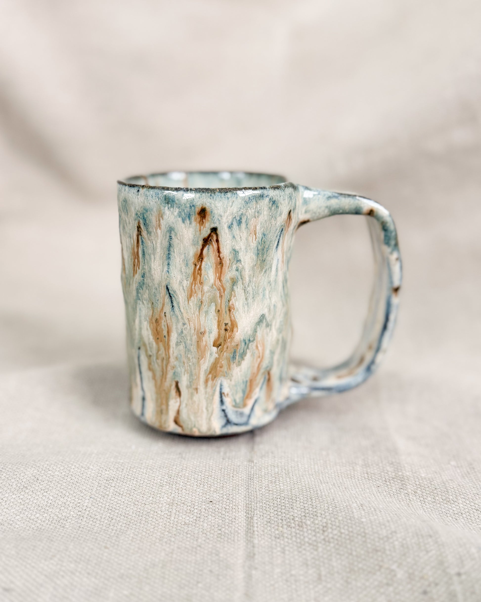 Marbled ceramic mug on a neutral background