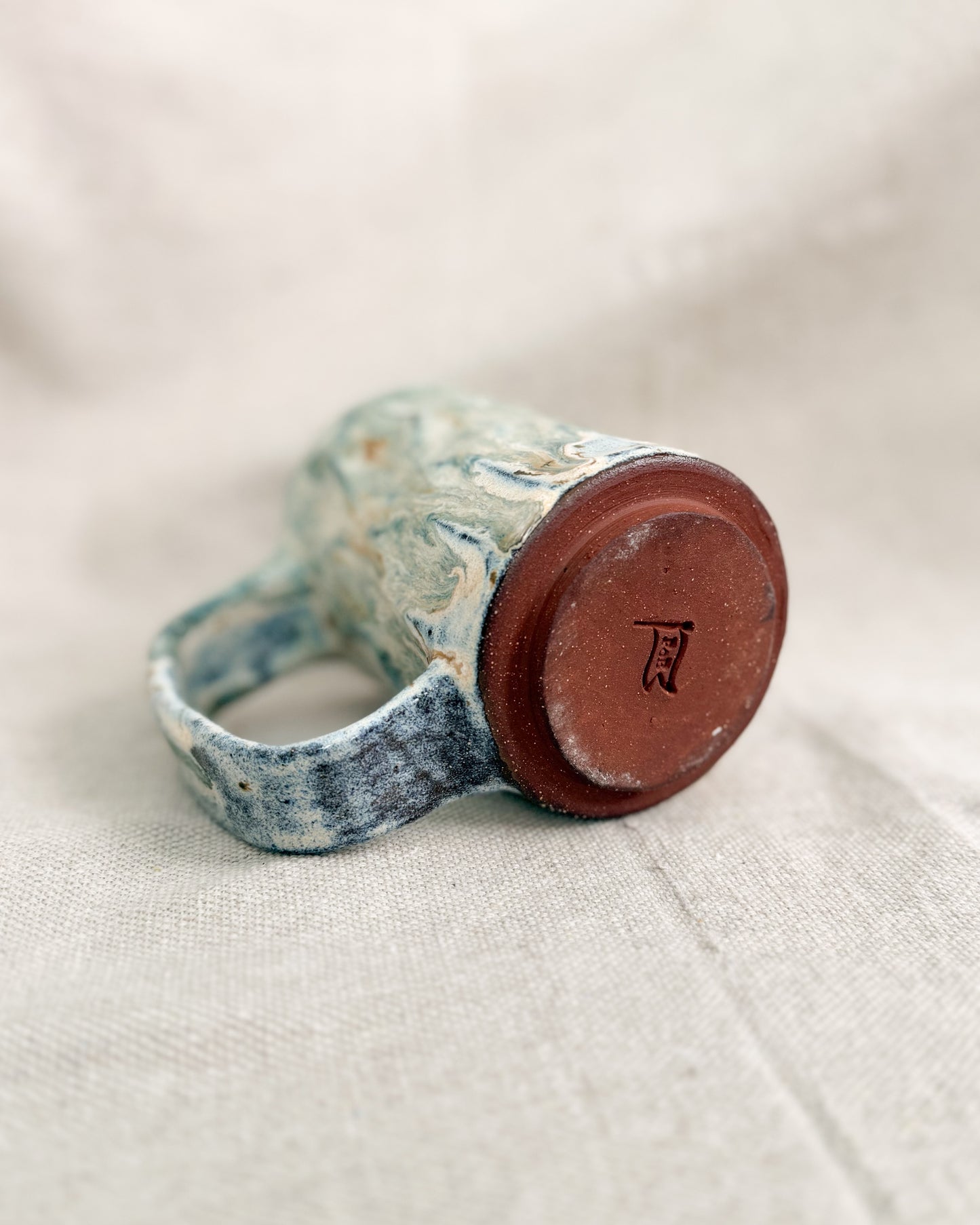 Ceramic mug  on a light fabric background