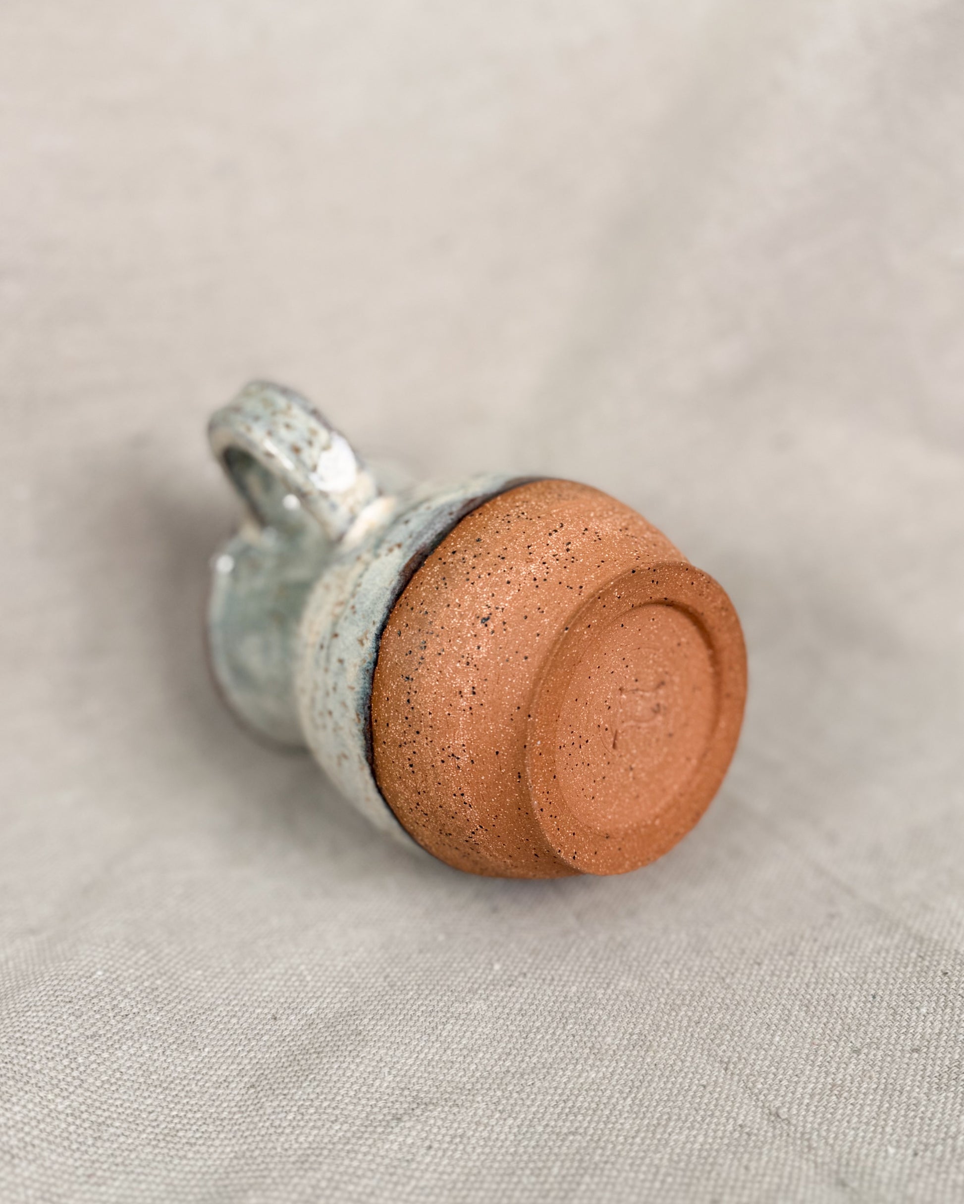 ceramic mug on a beige fabric background