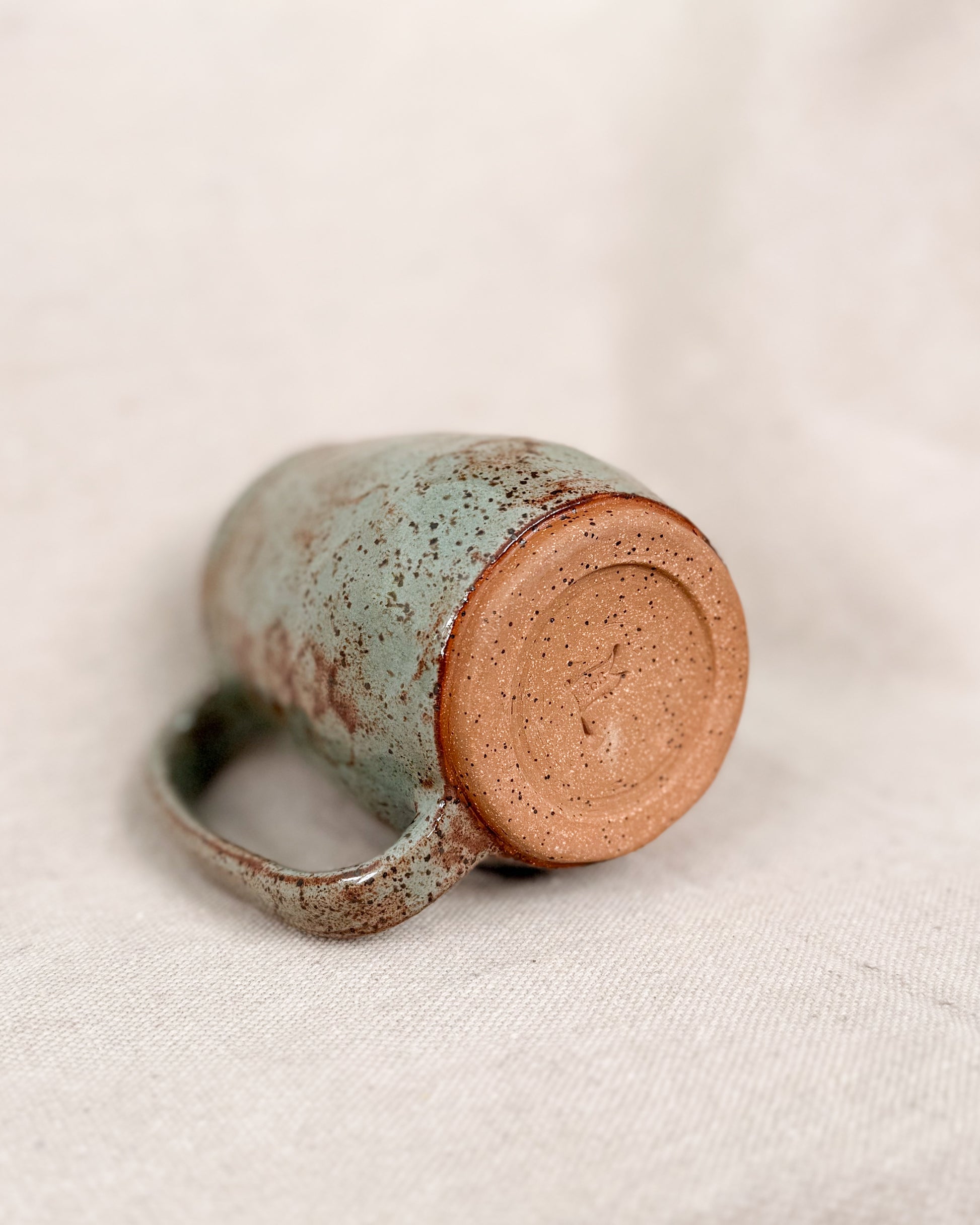 Ceramic mug with a textured surface on a light background