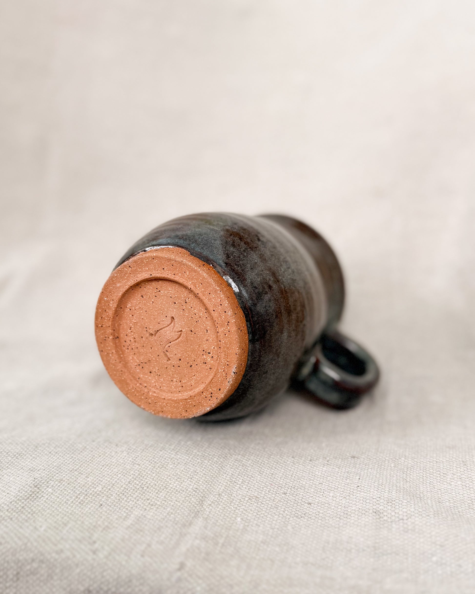 Ceramic mug on a light fabric background