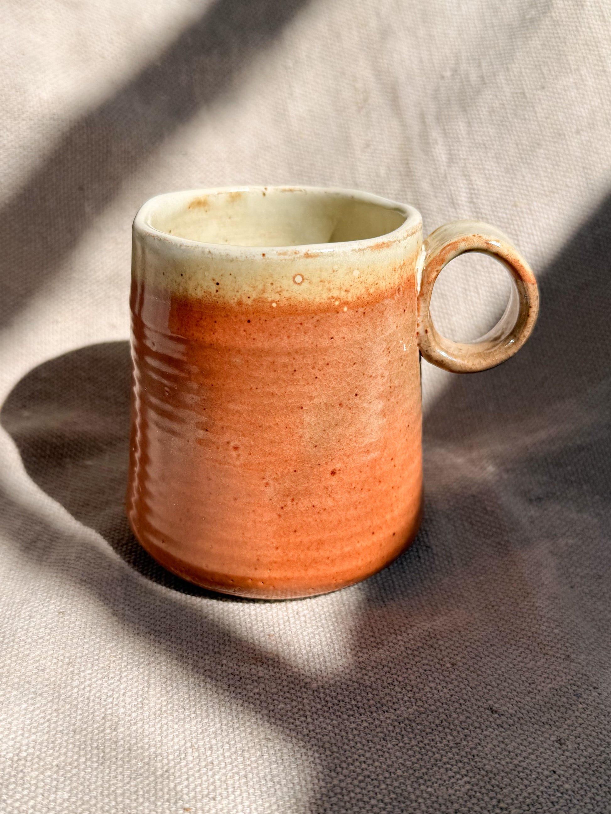 Ceramic mug with a gradient finish on a textured surface