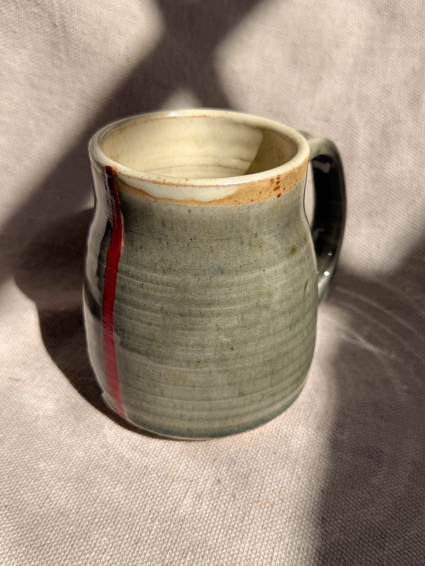 Ceramic mug with a textured surface on a neutral background