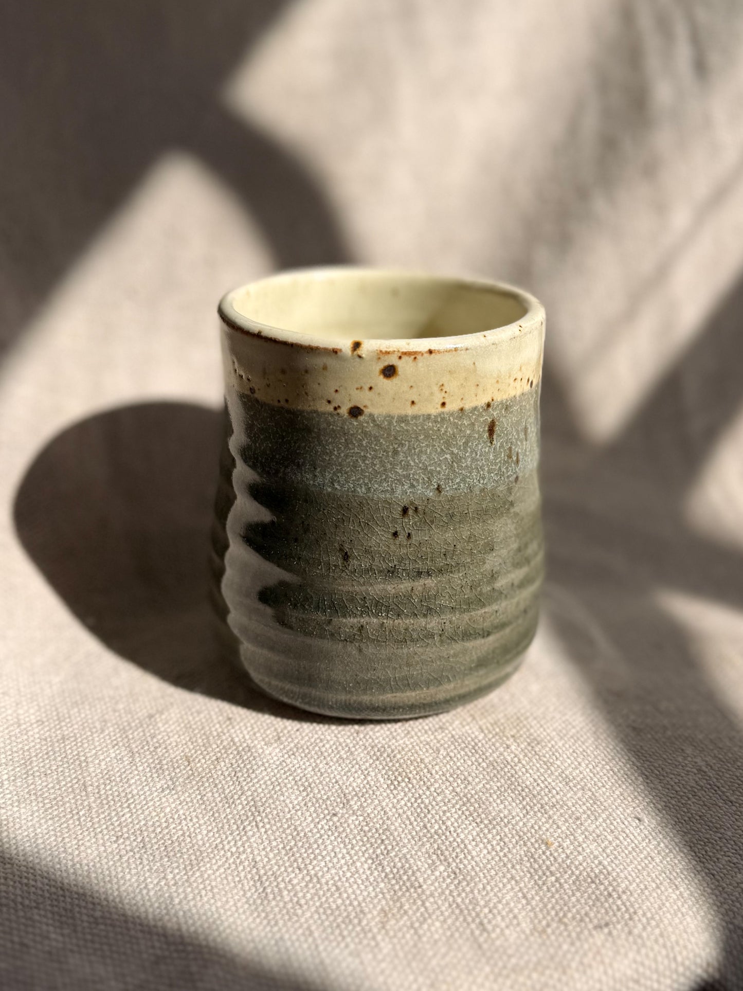 Ceramic cup with textured surface on a textured surface