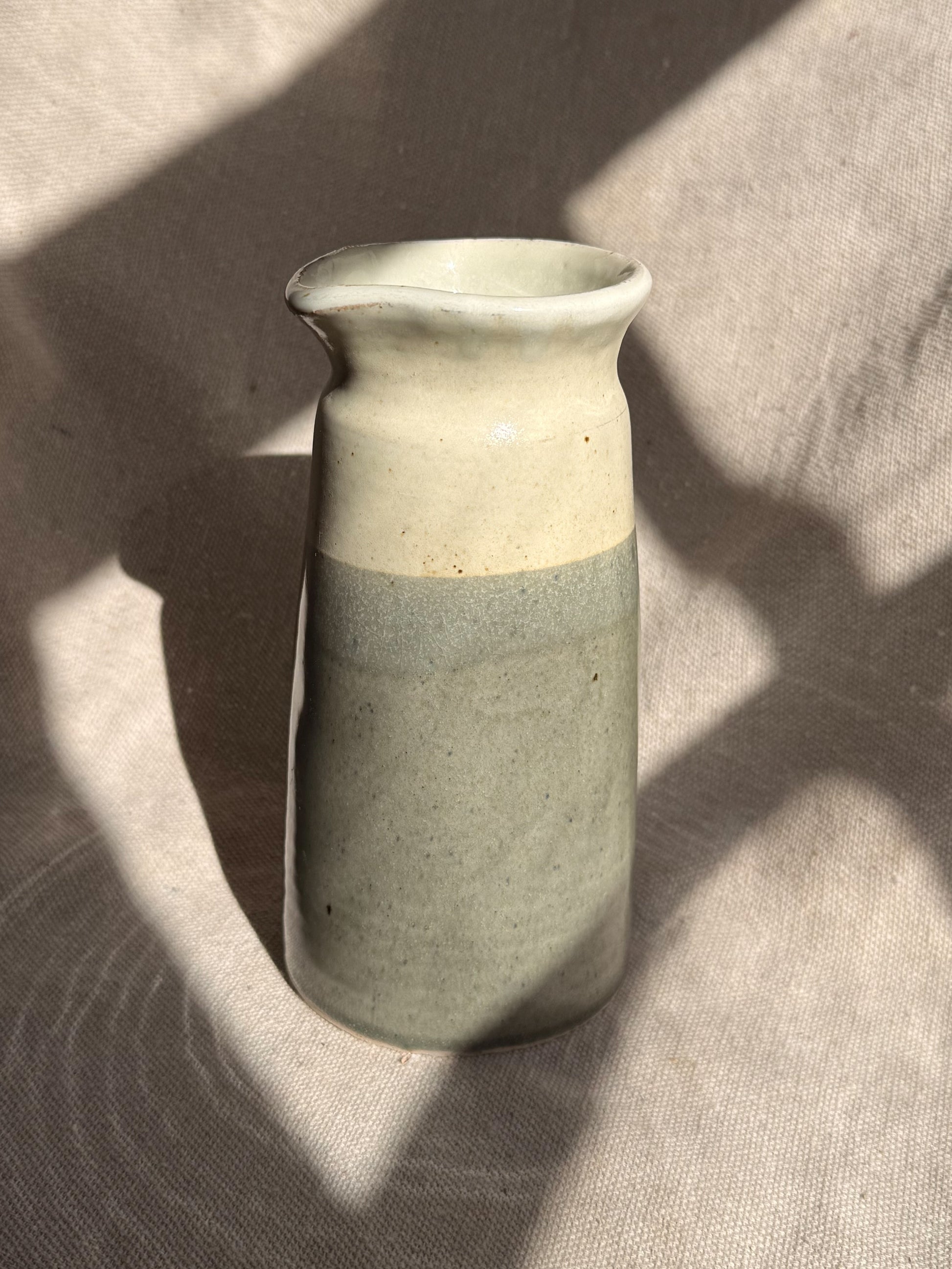 Two-toned ceramic vase on a textured surface