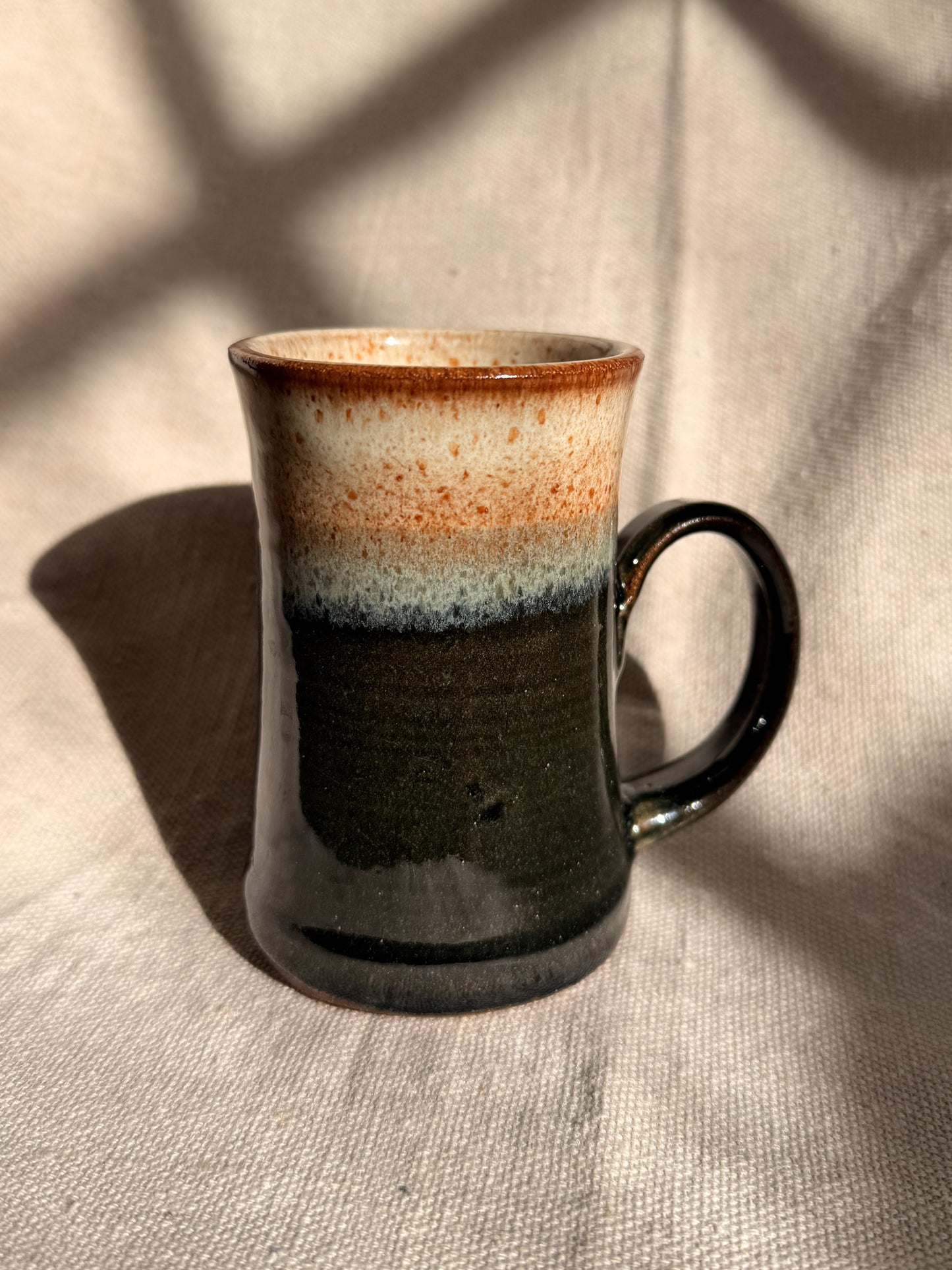 ceramic mug with red dot on it 