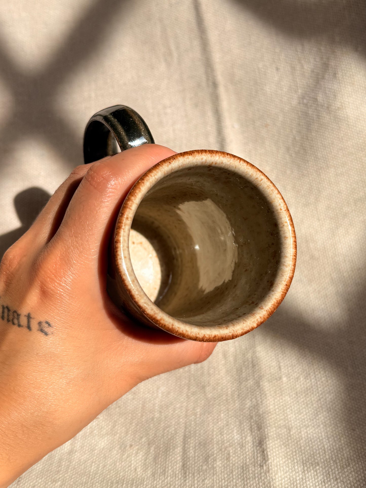 ceramic mug with red dot on it 