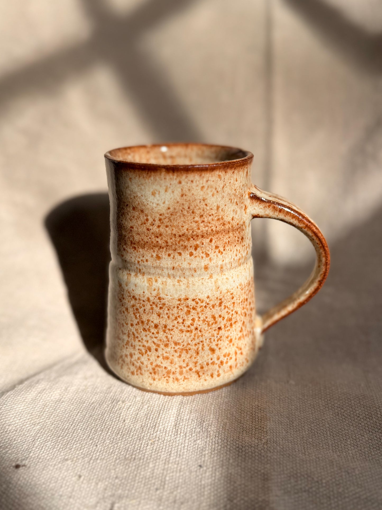 beige mug with red dot with a canvas background