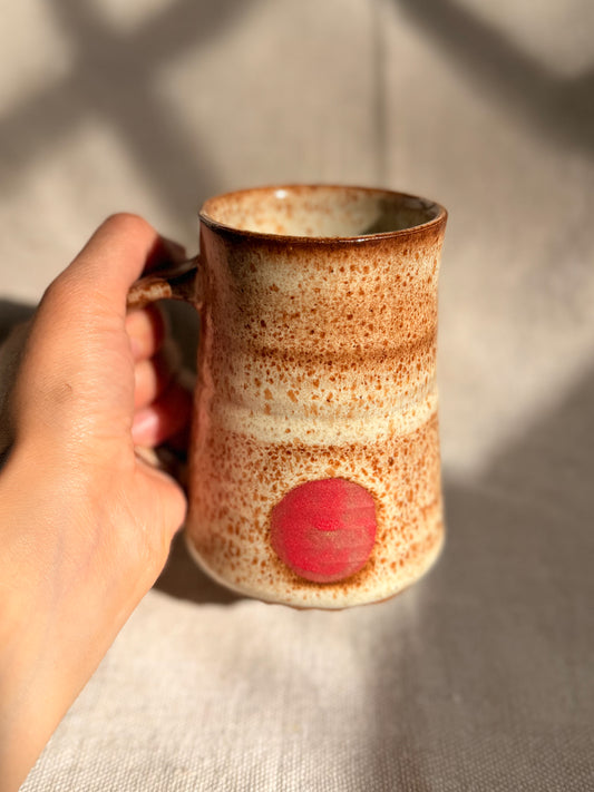 beige mug with red dot with a canvas background