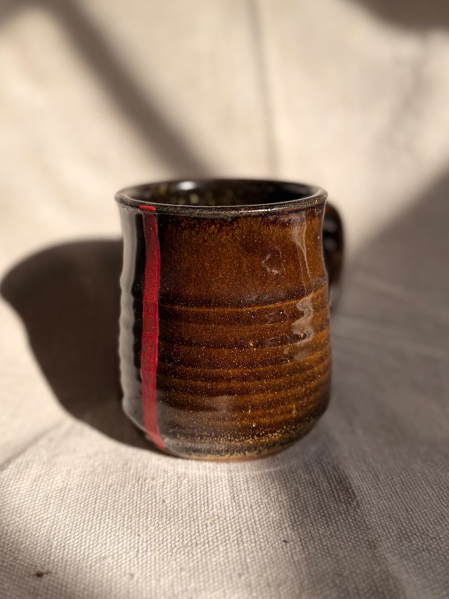 ceramic mug with red line with a canvas backgroud
