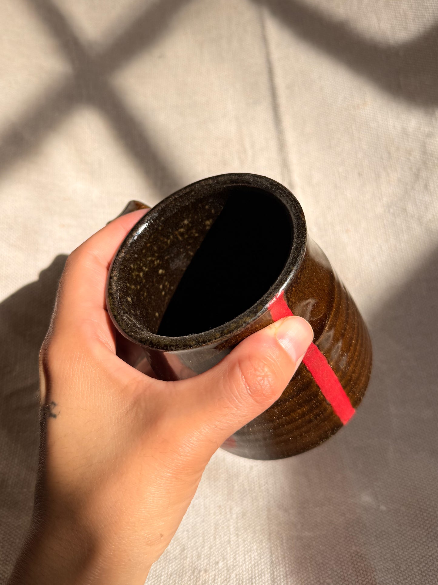 ceramic mug with red line with a canvas backgroud
